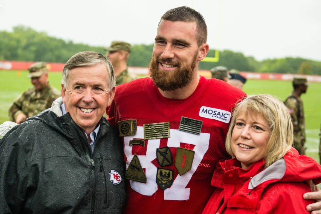 Travis Kelce alongside his parents at the NFL Draft, a moment marking the beginning of his illustrious career. and also a start of Travice Kelce net worth