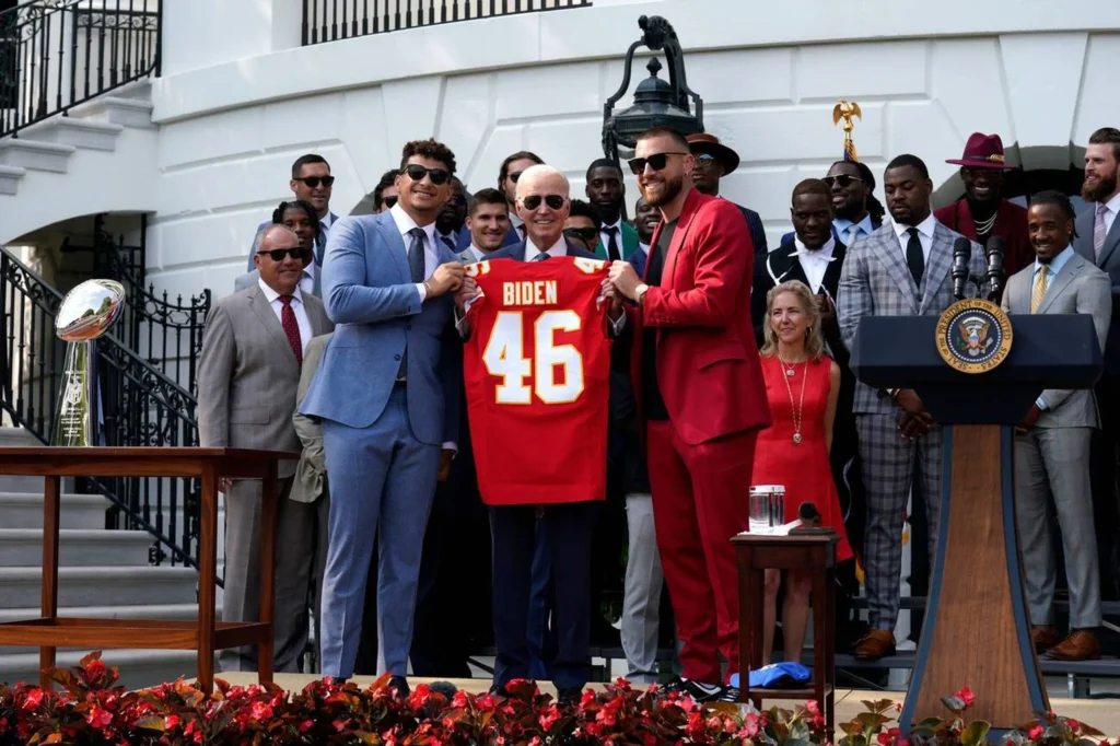 Travis Kelce with President Joe Biden during the 2023 Super Bowl visit, showcasing his influence beyond football.