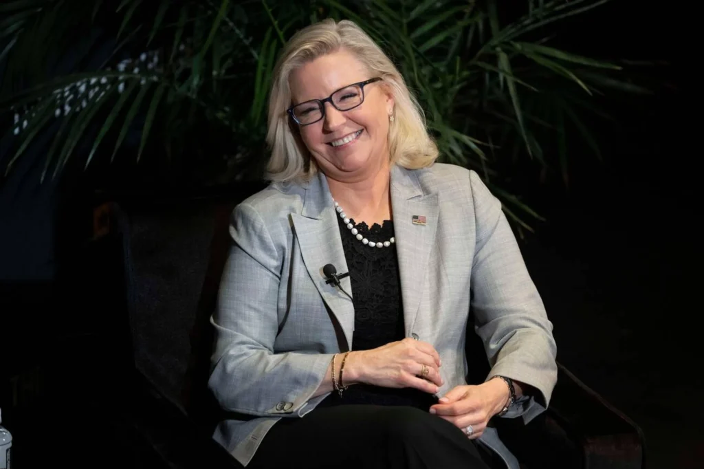 Liz Cheney autographing copies of her memoir 'Oath and Honor' for fans at a book event