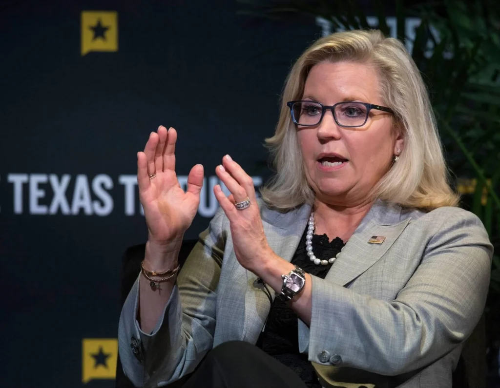 Liz Cheney posing with her father, former Vice President Dick Cheney, at a public event.