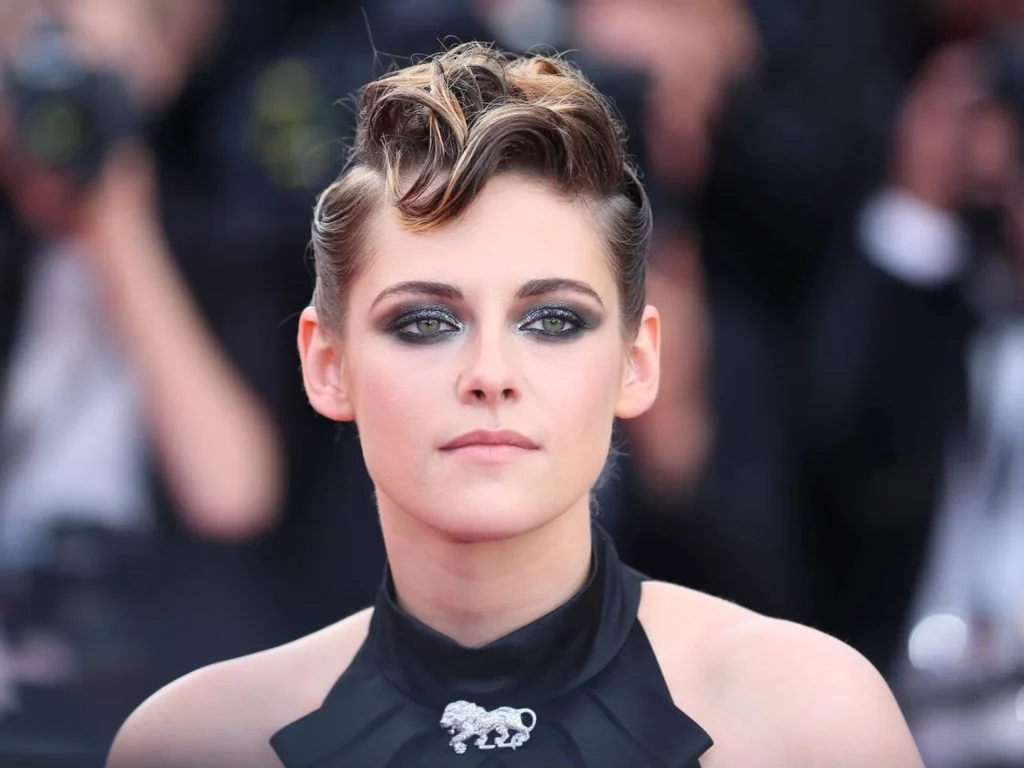 Kristen Stewart in a high-fashion portrait for Vogue 2024, wearing a sleek black leather jacket and minimal makeup, staring intensely at the camera