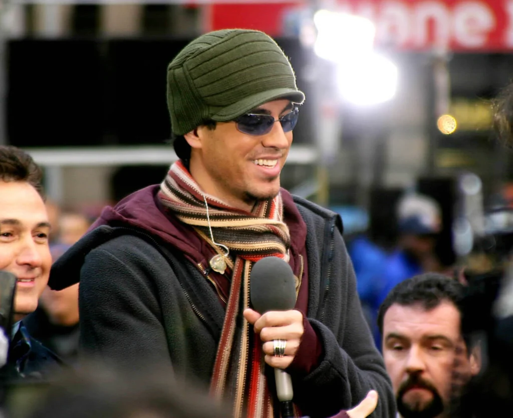 Enrique Iglesias performing at a concert, captivating his audience with his electrifying stage presence. Enrique Iglesias net worth has been significantly boosted by his global tours.