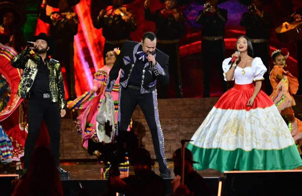 Angela Aguilar on stage with fans cheering, boosting her popularity and Angela Aguilar net worth through live performances.